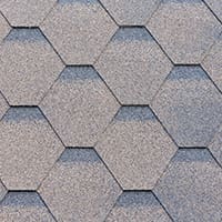 A close-up of a roof made with premium shingles that give a diamond shape to the roofing pattern